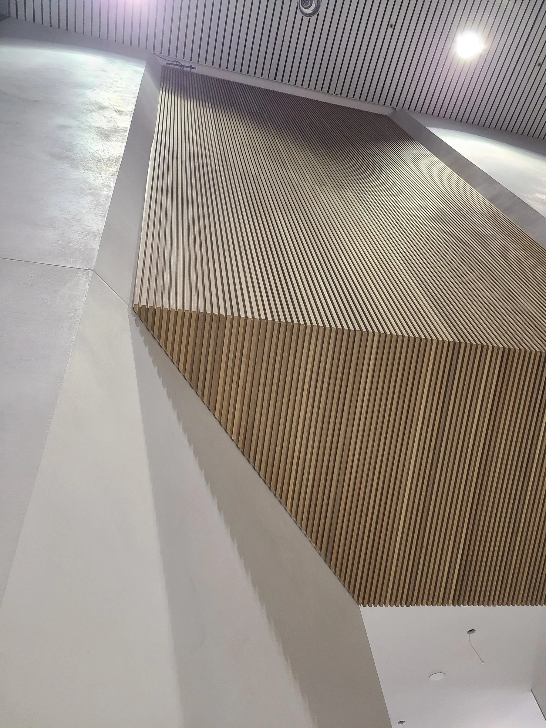 An angled white oak slat wall installed by Bang On Carpentry